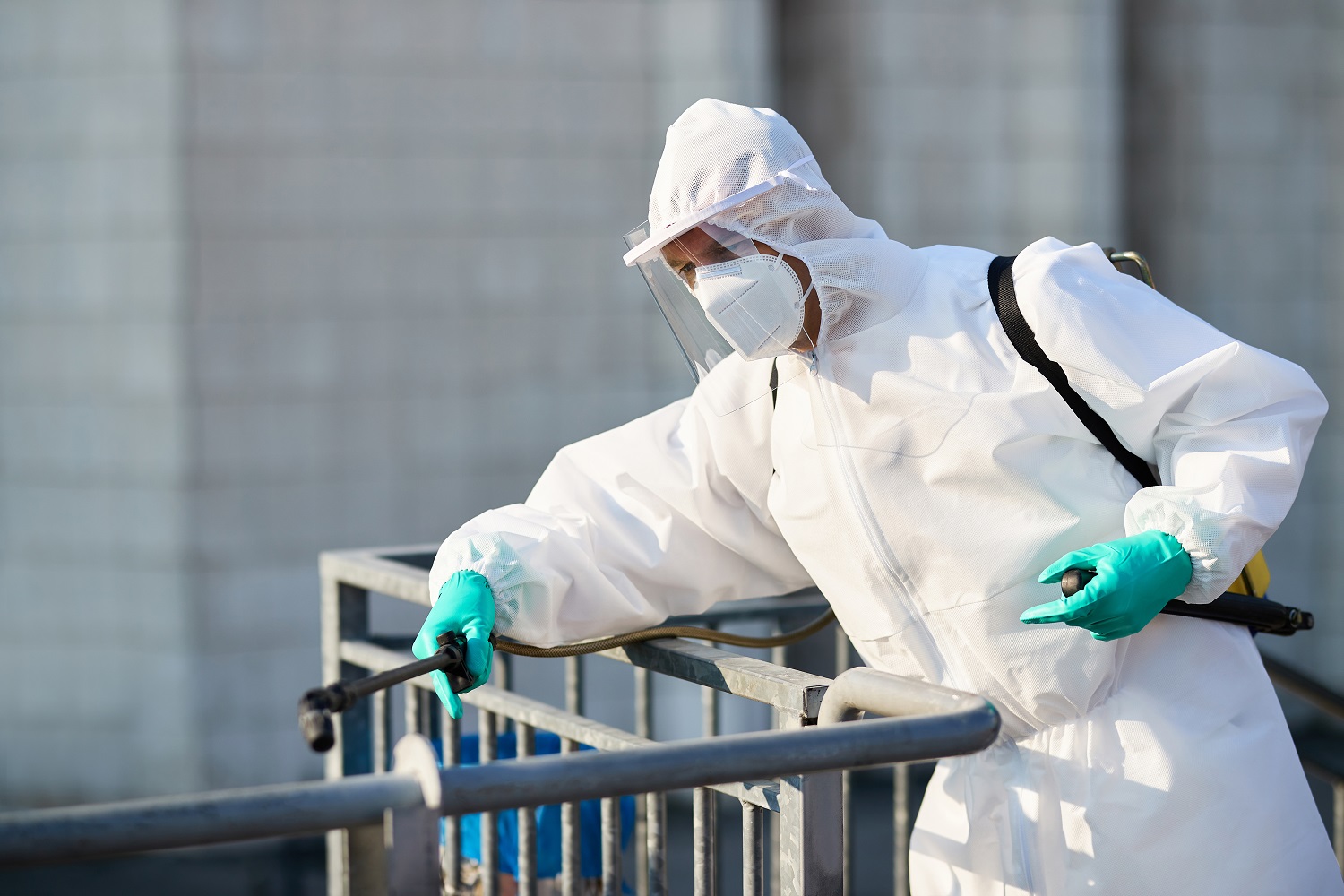 Disinfectant worker sanitizing city area in order to prevent spr
