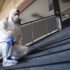 Person in white chemical protection suit disinfecting public corridors and steps to stop spreading highly contagious corona virus. Person in white chemical protection suit disinfecting public corridors and steps to stop spreading highly contagious corona virus.